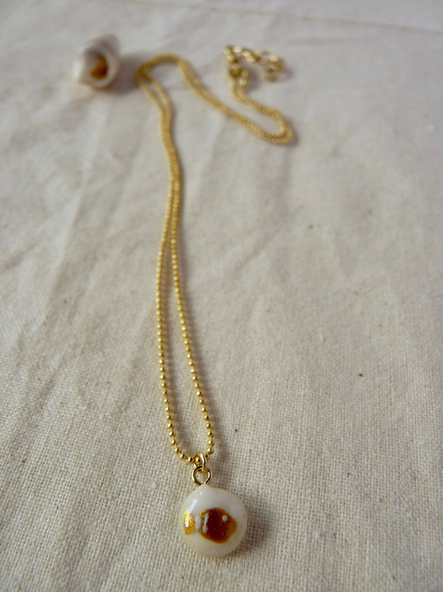 Tiny shell necklace with painting, little fish
