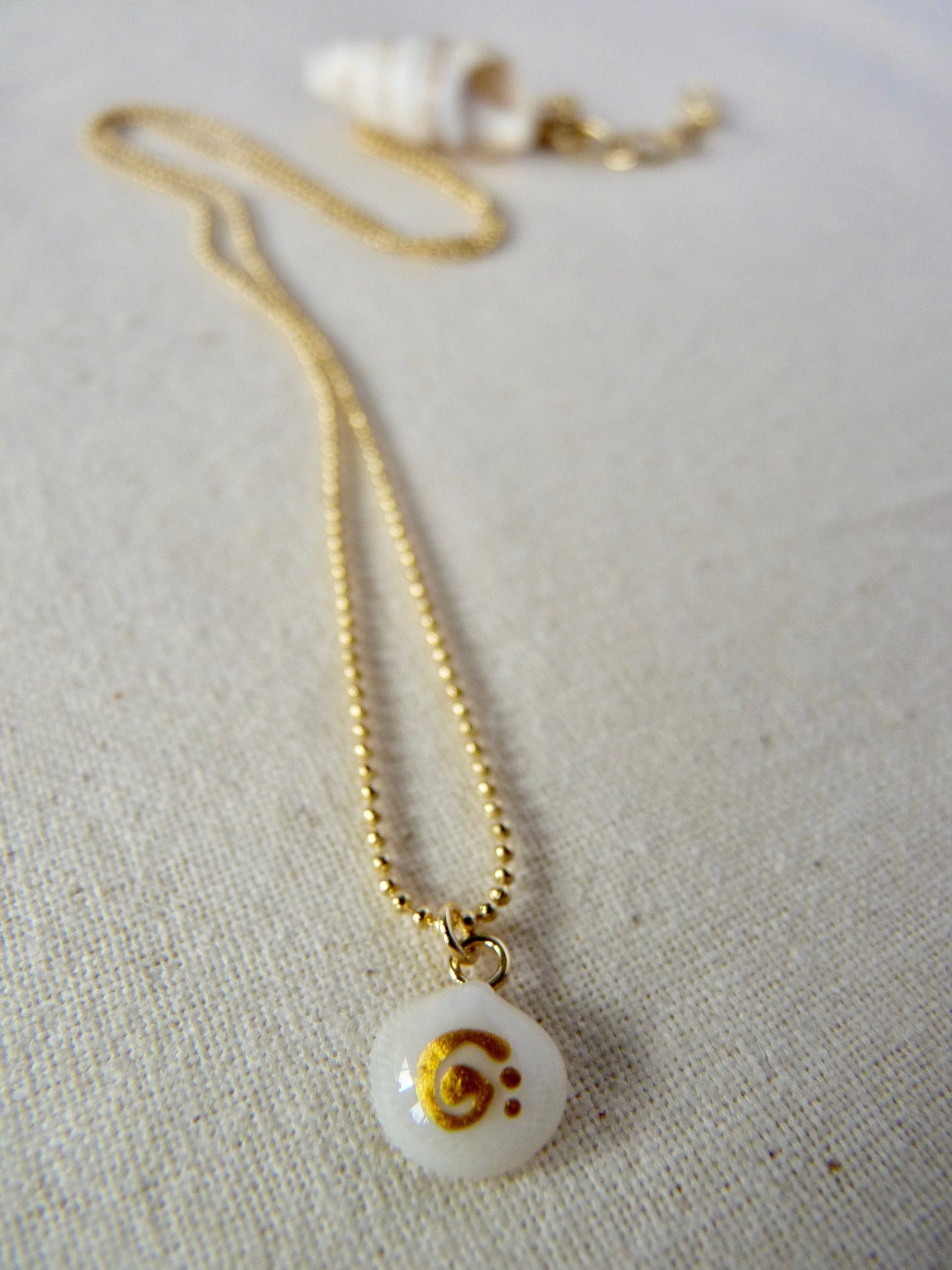Tiny shell necklace with painting, little swirl